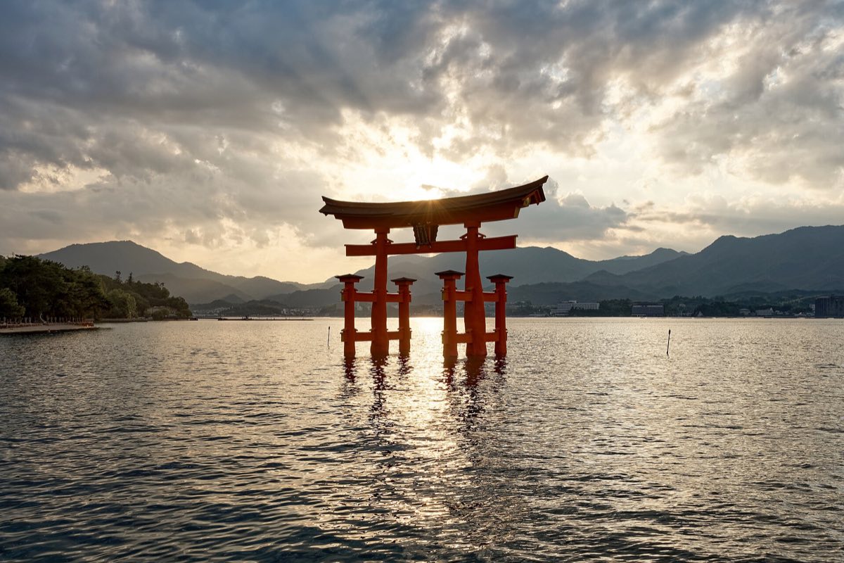 The Great Torii of Itsukushima Shrine standing in the water at sunset, Miyajima